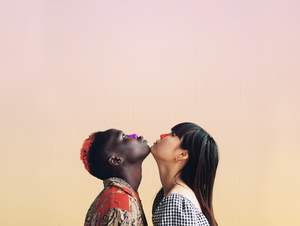 A man and a woman looking upwards with the best colorful and organic sunscreen on their noses.